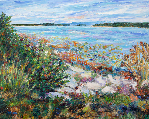 Painting of a coastal landscape with rocks, plants, and a blue bay with distant hills. Palette knife oil landscape.
