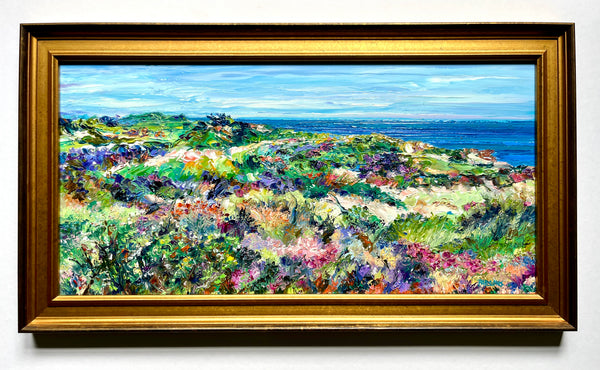 Colorful beach painting with a gold frame.